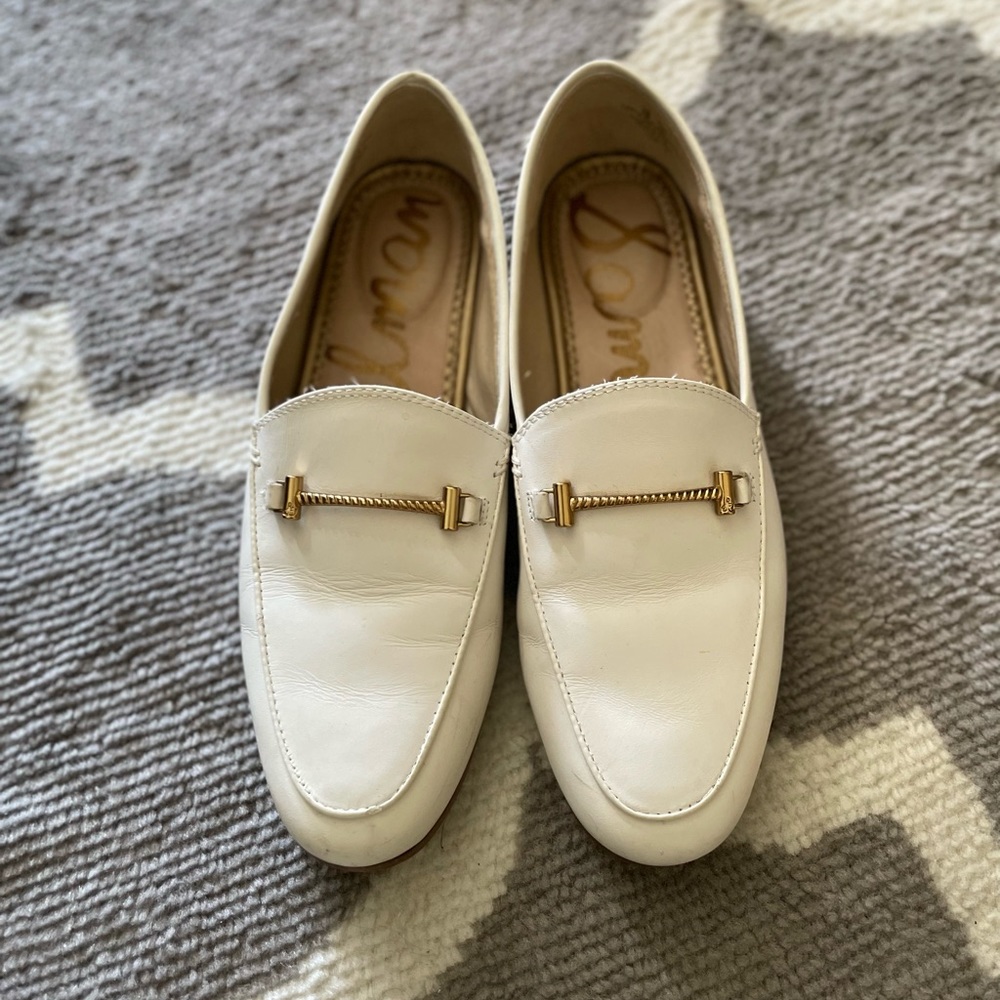 White Sam Edelman loafers with gold buckle detail